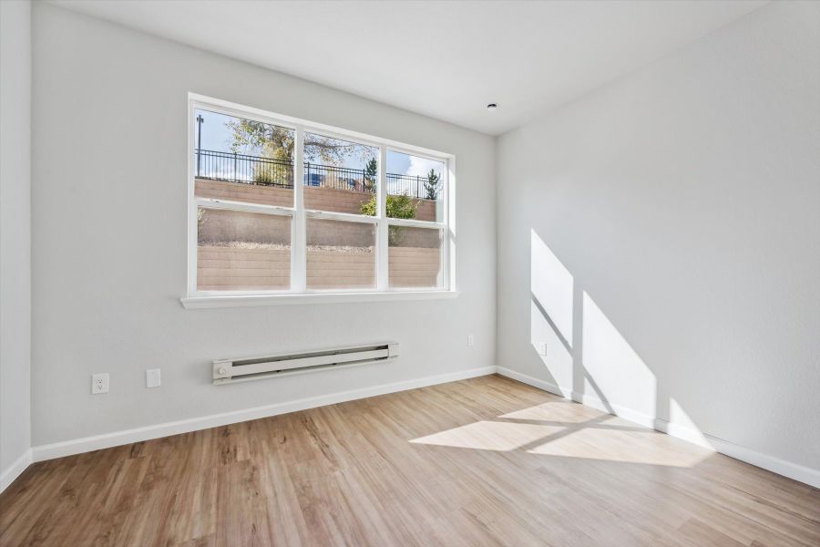 A room with a window and a wood floor. A room with a window and a wood floor.