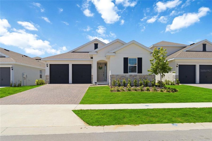 Front exterior of a new home in , Clermont, FL, highlighting curb appeal (Image 26).