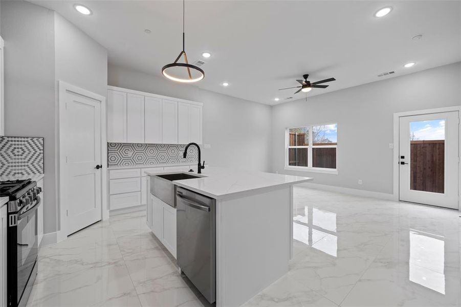 Kitchen with gas stove, recessed lighting, a sink, stainless steel dishwasher, and marble finish floor