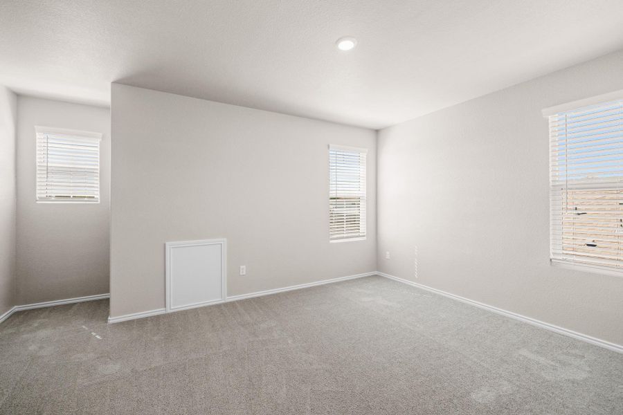 Carpeted spare room featuring baseboards