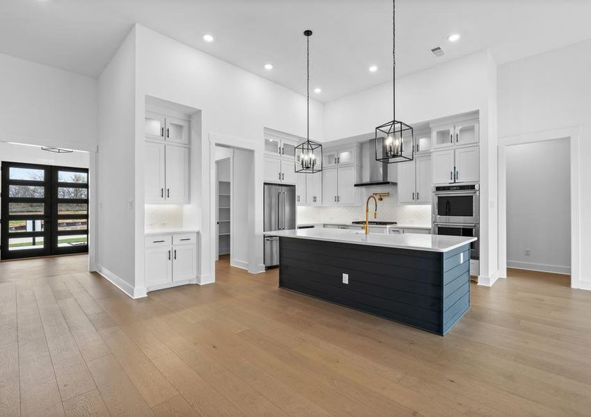 The kitchen has gorgeous white cabinetry with black hardware.