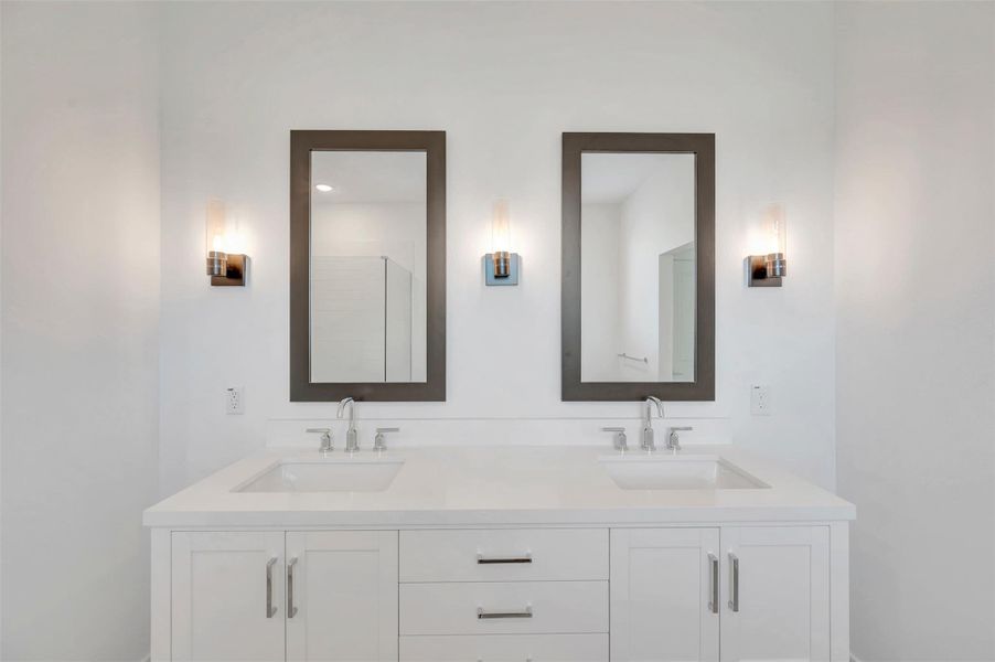 Luxurious primary bath with freestanding vanity and dual sinks