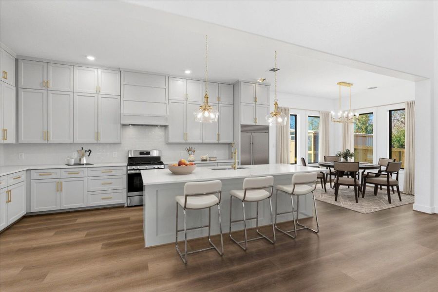Just beyond the foyer, a stunning kitchen takes center stage, featuring an oversized island with additional seating, two statement pendant lights, a gas stove, and custom solid-wood cabinetry. (Virtually Staged)
