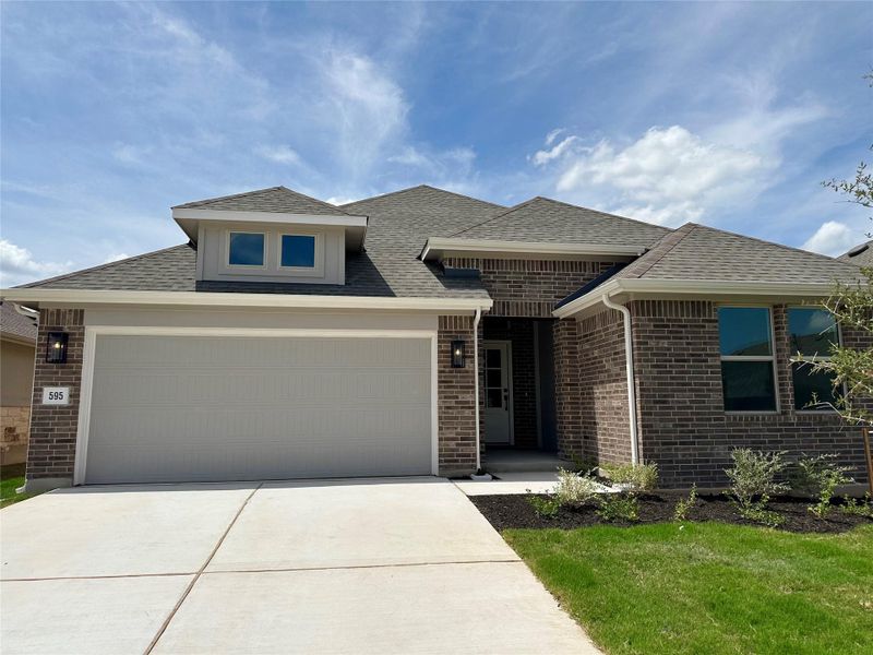 Front exterior of a new home in Crosswinds, Kyle, TX, highlighting curb appeal (Image 2). Front exterior of a new home in Crosswinds, Kyle, TX, highlighting curb appeal (Image 2).