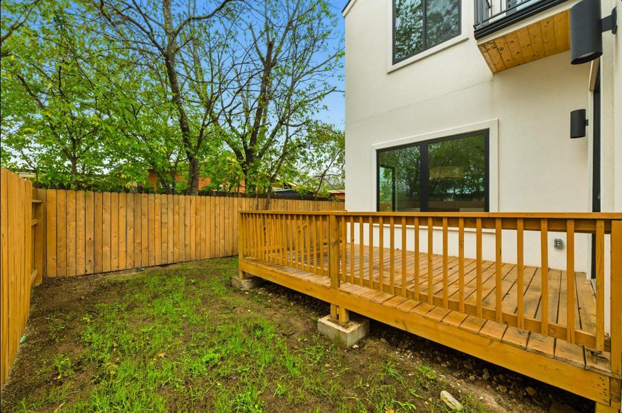 Fenced backyard with a deck