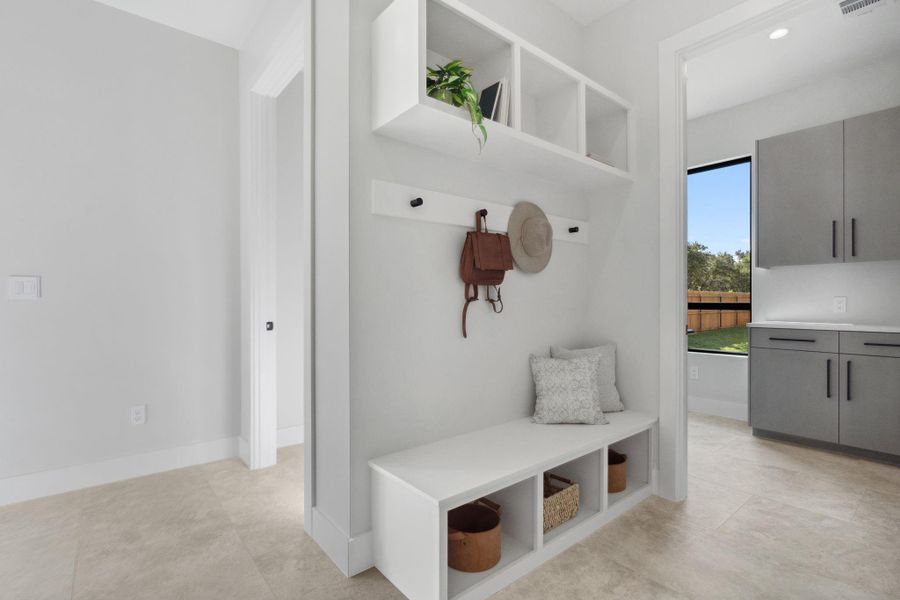 Entry from the garage leads to the mudroom, powder room and laundry.