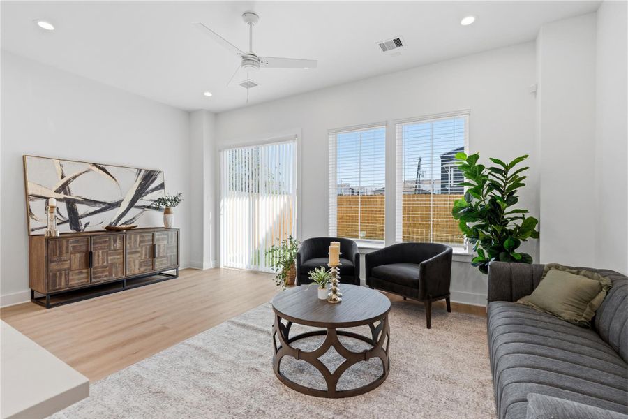 Open concept floorplan that connects the kitchen, dining, and living for a seamless spatial flow. Vinyl plank flooring provides a warm, organic base to the airy volume.