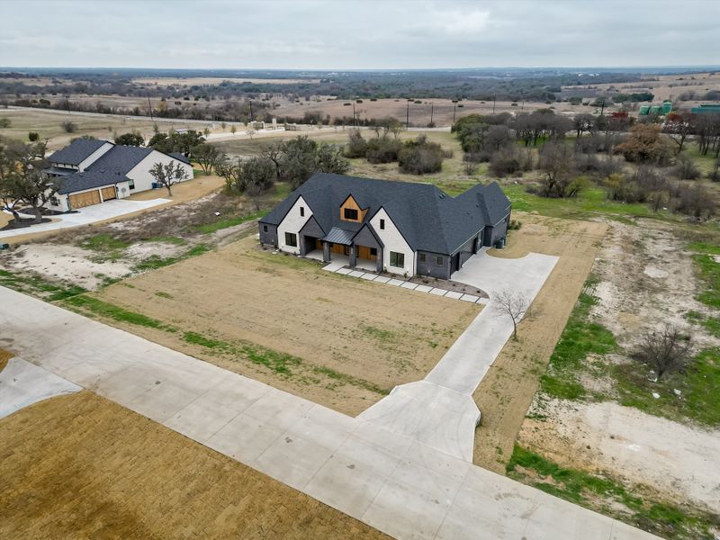 Front exterior of a new home in Summit Ranch, Aledo, TX, highlighting curb appeal (Image 32). Front exterior of a new home in Summit Ranch, Aledo, TX, highlighting curb appeal (Image 32).