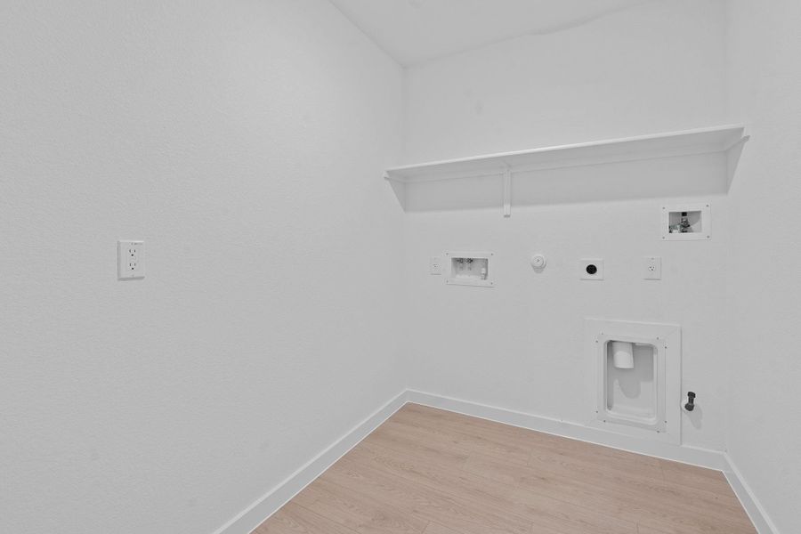 Laundry area featuring gas dryer hookup, light wood-style floors, washer hookup, and hookup for an electric dryer