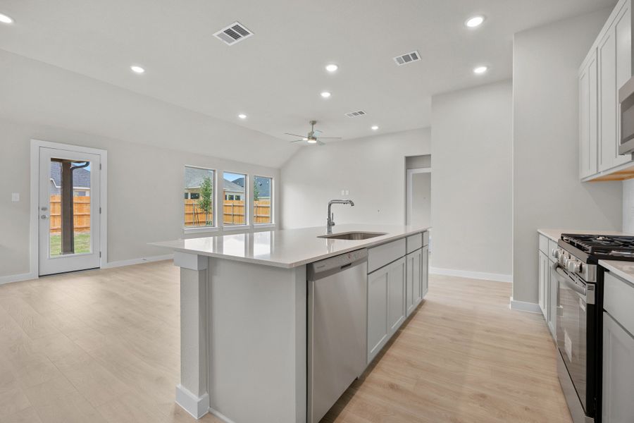 Kitchen in the Brazos home plan by Trophy Signature Homes – REPRESENTATIVE PHOTO