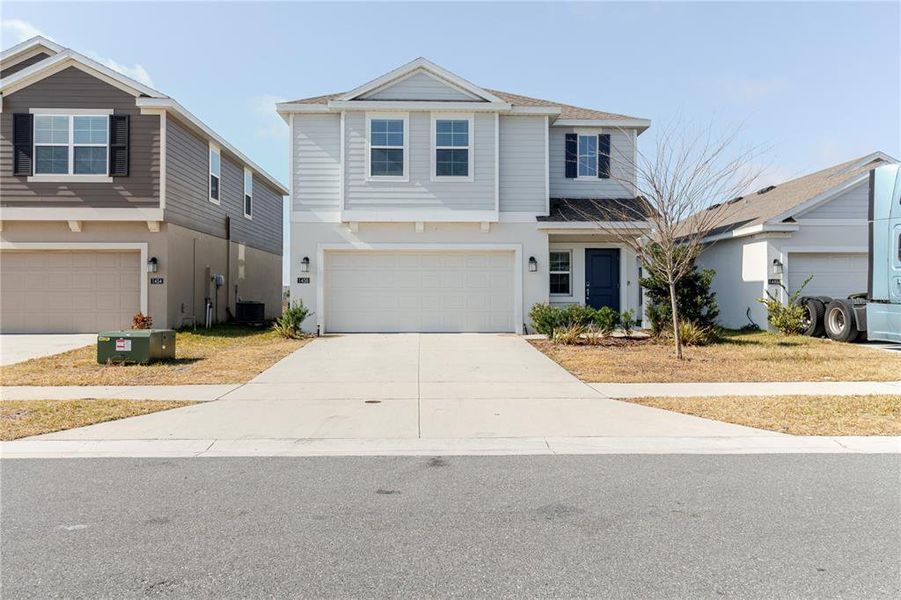 Front exterior of a new home in Peace Creek Reserve, Winter Haven, FL, highlighting curb appeal (Image 1). Front exterior of a new home in Peace Creek Reserve, Winter Haven, FL, highlighting curb appeal (Image 1).