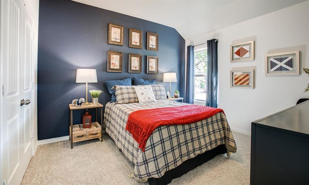 Carpeted bedroom featuring baseboards and vaulted ceiling Carpeted bedroom featuring baseboards and vaulted ceiling
