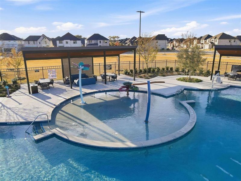 Community pool with a patio and a residential view