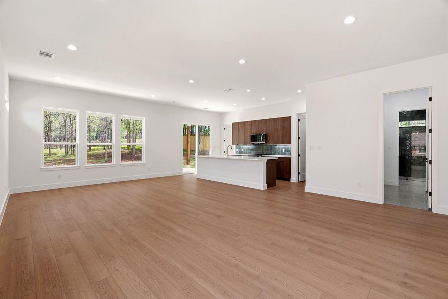 Unfurnished living room with light wood-type flooring and recessed lighting