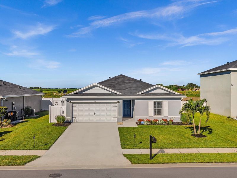 Front exterior of a new home in , Belle Glade, FL, highlighting curb appeal (Image 28).