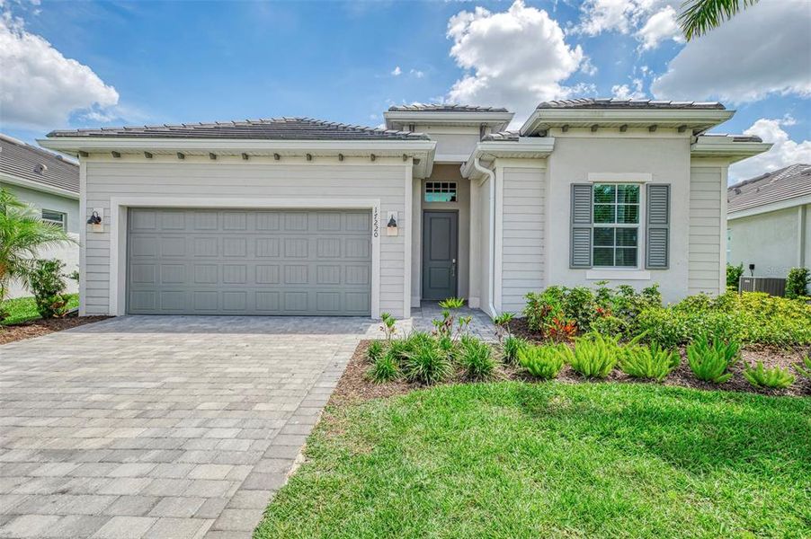 Front exterior of a new home in Wellen Park Golf & Country Club, Venice, FL, highlighting curb appeal (Image 1). Front exterior of a new home in Wellen Park Golf & Country Club, Venice, FL, highlighting curb appeal (Image 1).