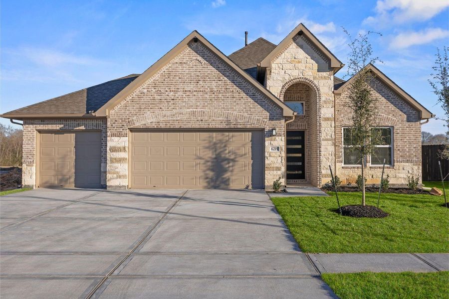 Front exterior of a new home in Foxtail Palms, Manvel, TX, highlighting curb appeal (Image 1). Front exterior of a new home in Foxtail Palms, Manvel, TX, highlighting curb appeal (Image 1).