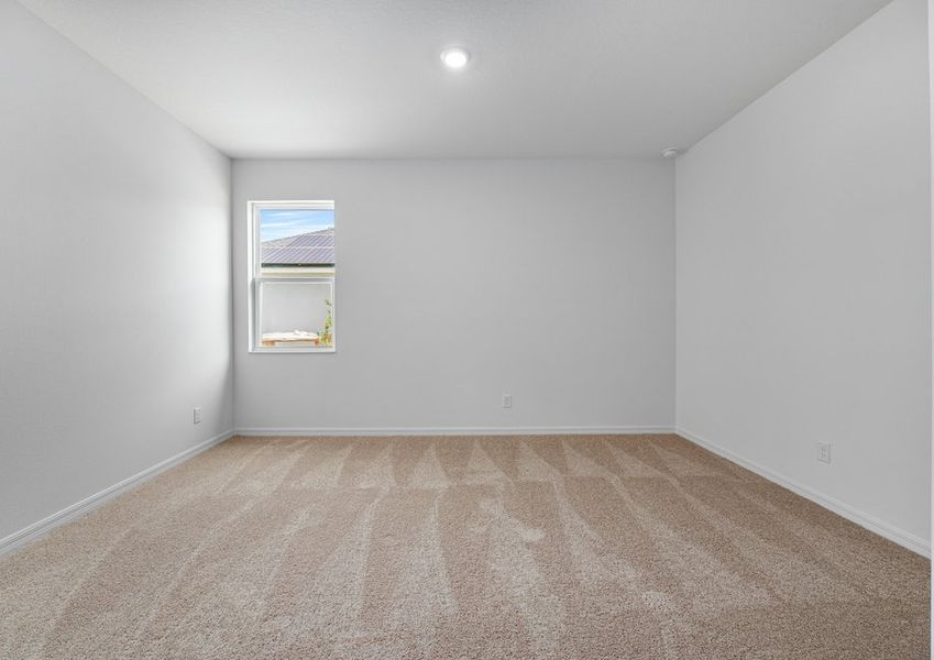 Master bedroom with lush carpet flooring