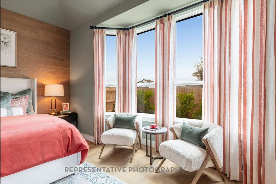 Bedroom with wood finished floors and wooden walls