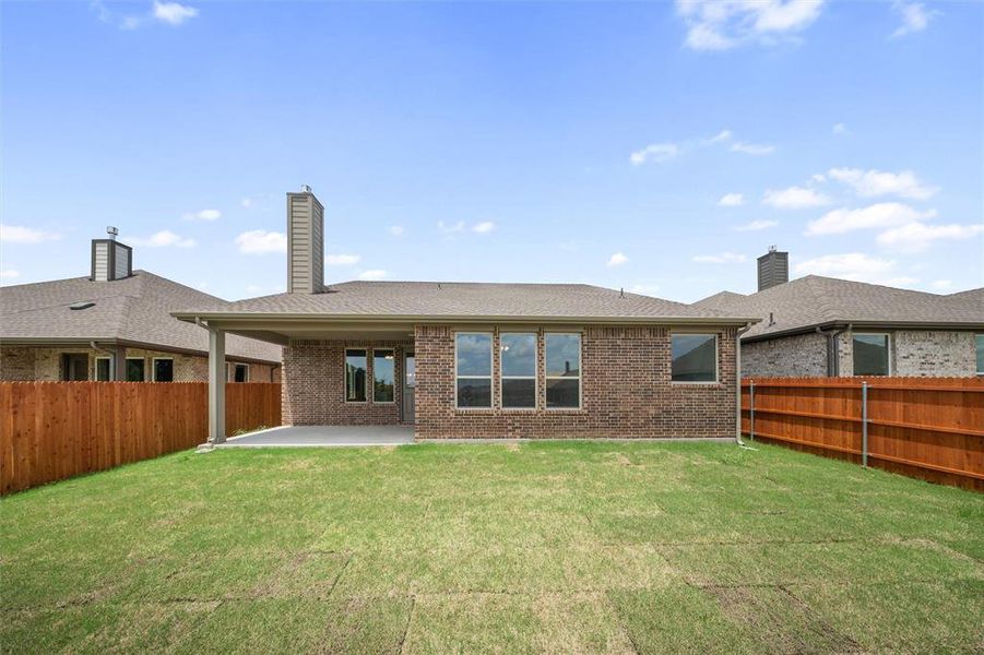 Back of house with a chimney, a patio, roof with shingles, and a fenced backyard