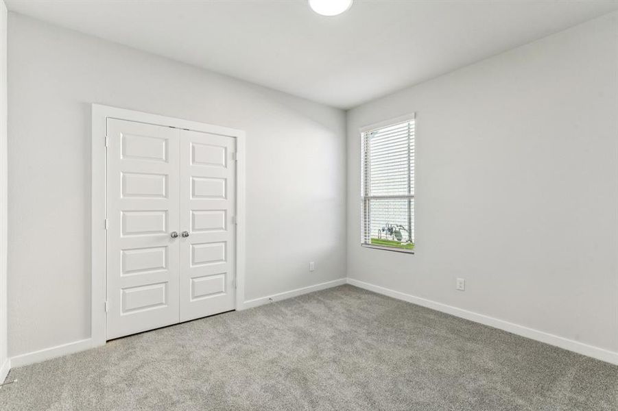 Bedroom in the Wimbledon home plan by Trophy Signature Homes – REPRESENTATIVE PHOTO