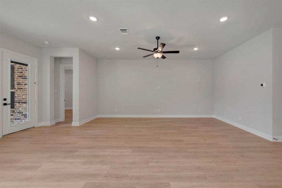 Spare room featuring ceiling fan, light wood finished floors, and recessed lighting