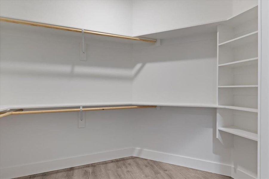 Spacious closet with hardwood / wood-style floors