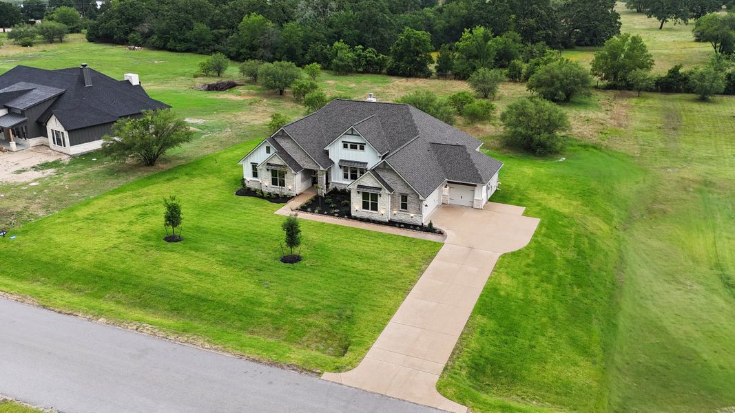 Front exterior of a new home in Windmill Hill, Bryan, TX, highlighting curb appeal (Image 28).