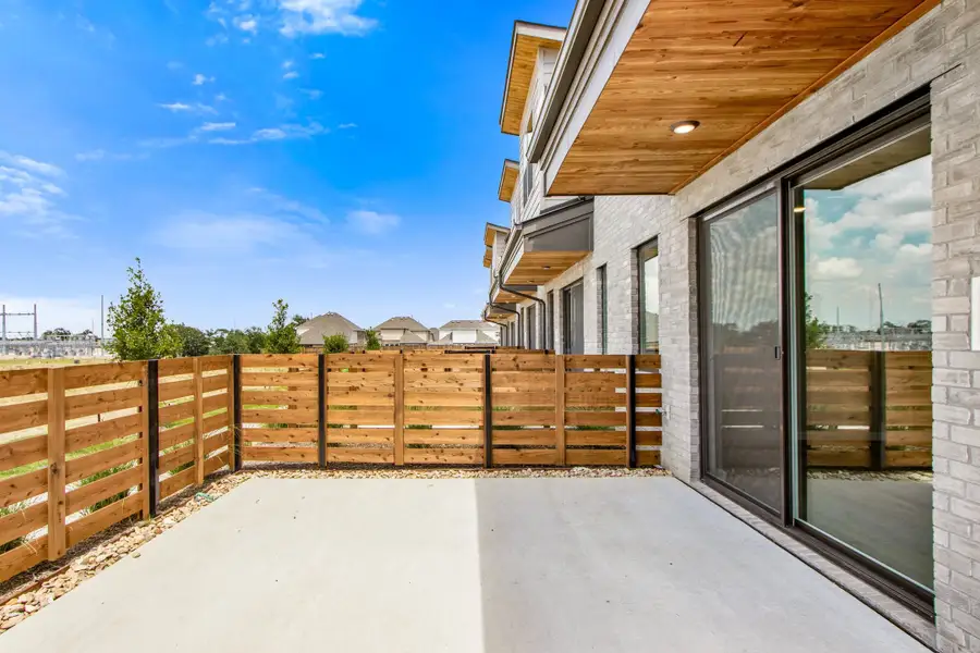 Exterior details and patio area of a home in Wildridge, Oak Point (Image 3).