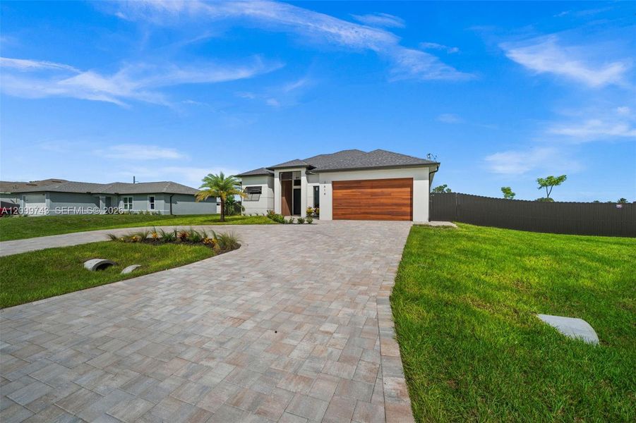 Front exterior of a new home in , Cape Coral, FL, highlighting curb appeal (Image 24).