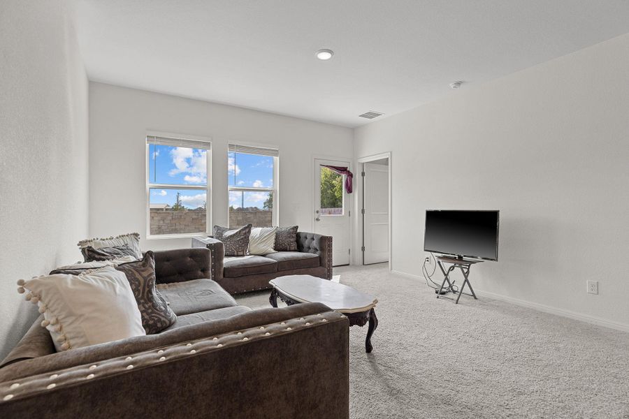 Carpeted living area with baseboards Carpeted living area with baseboards