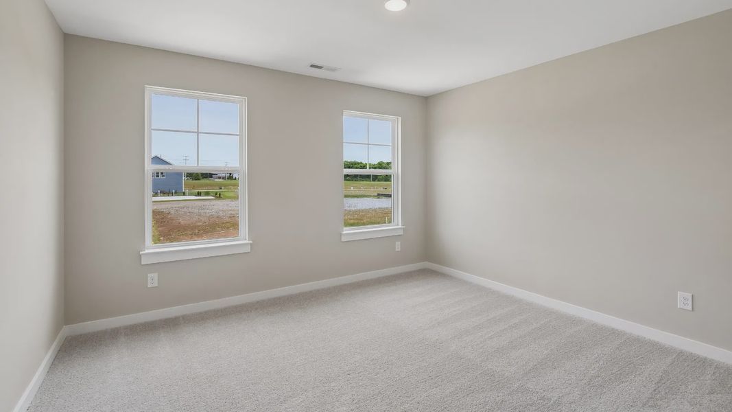 Bedroom with walk-in closet and windows Bedroom with walk-in closet and windows
