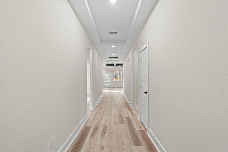 Hallway with light hardwood / wood-style flooring