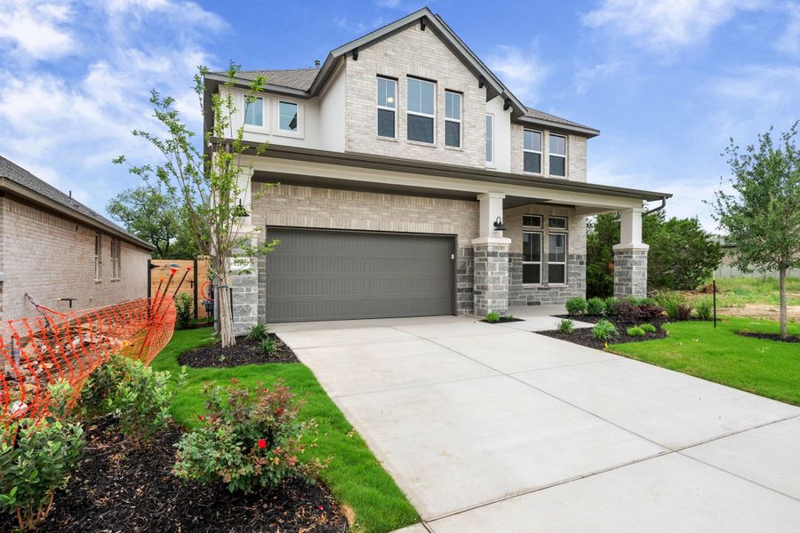 Front exterior of a new home in Wolf Ranch, Georgetown, TX, highlighting curb appeal (Image 26).