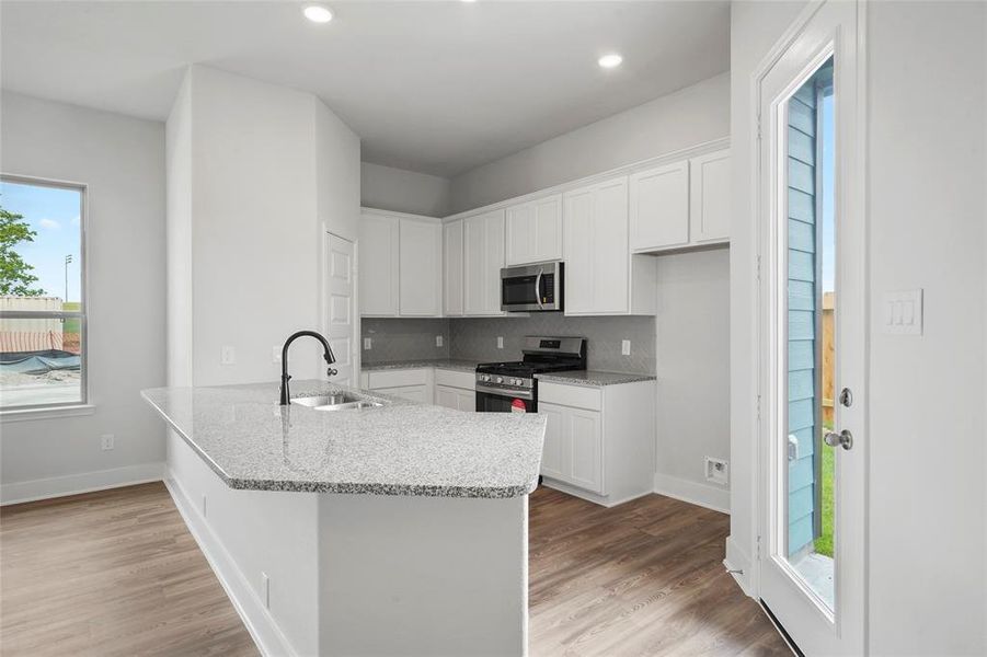 Kitchen with plenty of countertops and opens up to family room