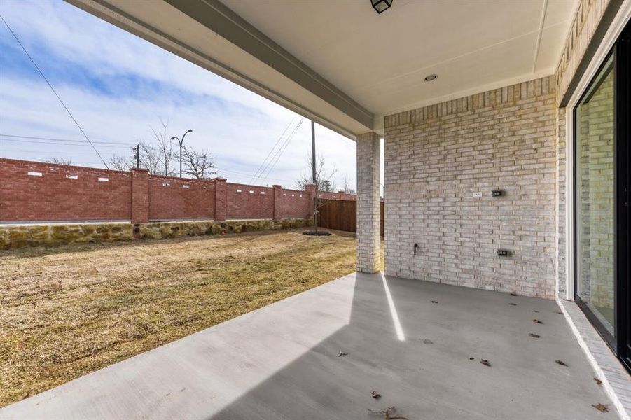 Fenced backyard with a patio area