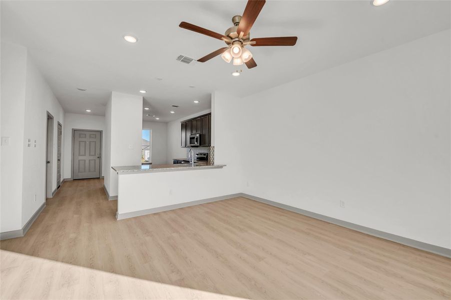 Unfurnished living room with recessed lighting, light wood finished floors, and a ceiling fan
