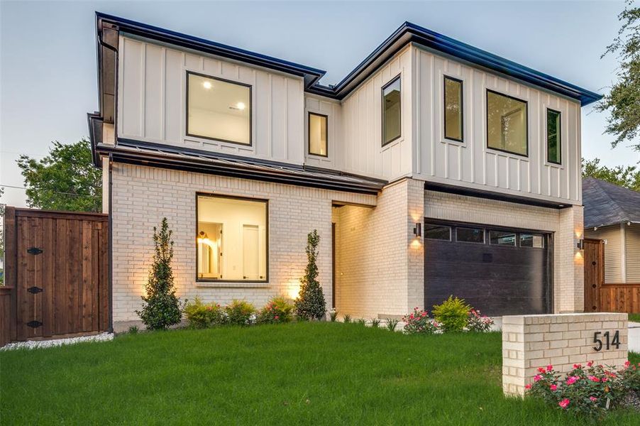 View of front of home with brick siding, an attached garage, board and batten siding, and concrete driveway View of front of home with brick siding, an attached garage, board and batten siding, and concrete driveway
