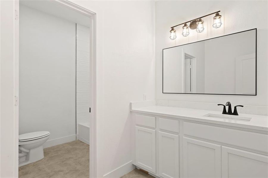 Full bathroom featuring vanity, toilet, and shower / bathtub combination