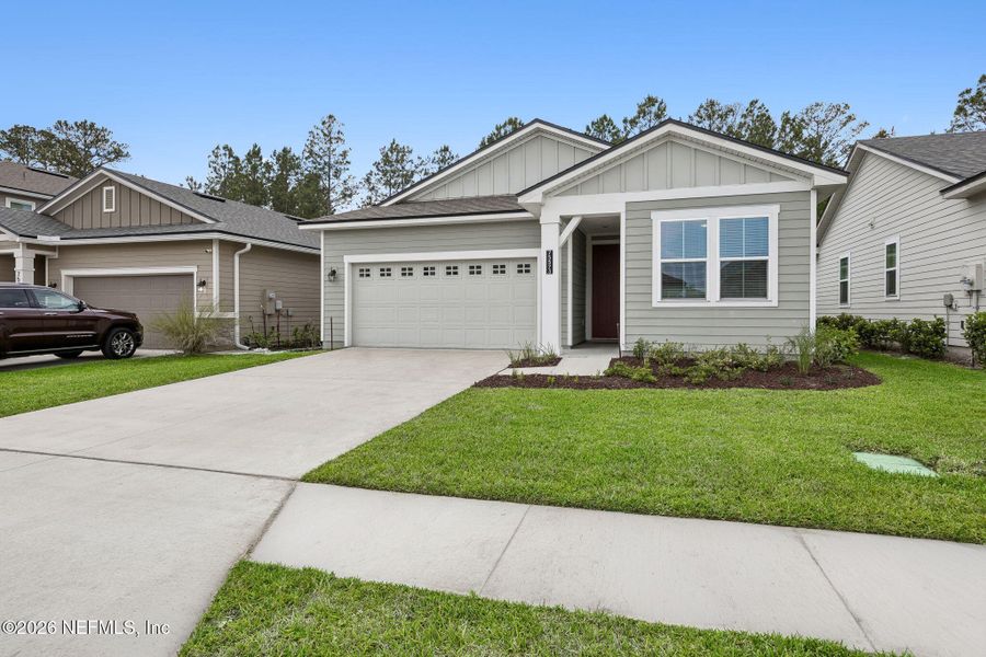 Front exterior of a new home in Tributary, Yulee, FL, highlighting curb appeal (Image 23).