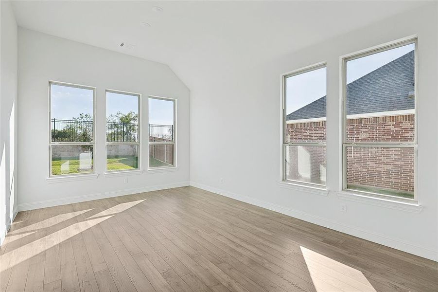 Bonus room featuring light hardwood / wood-style flooring and vaulted ceiling