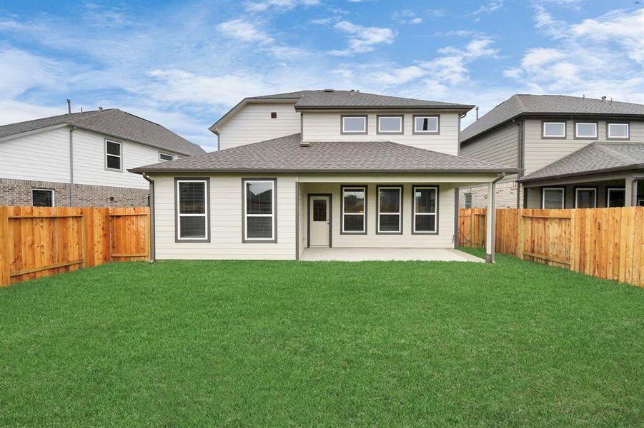 Discover the charm of this spacious backyard featuring a delightful covered patio. With ample room for both play and relaxation, it's the perfect outdoor haven.