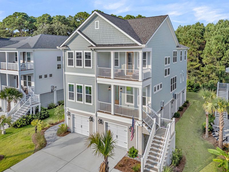 Front exterior of a new home in Overlook at Copahee Sound, Awendaw, SC, highlighting curb appeal (Image 2). Front exterior of a new home in Overlook at Copahee Sound, Awendaw, SC, highlighting curb appeal (Image 2).