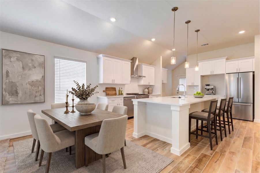 Modern kitchen with a large island, quartz countertops, white shaker-style cabinetry, pendant lights, stainless fixtures, and warm wood-look tile flooring. Two large windows bring in natural light and brighten the adjoining breakfast area. This photo has been virtually staged for visual reference.