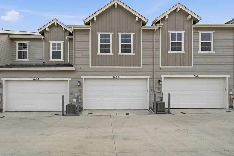 Front exterior of a new home in Trailstone Townhomes - The Westerly Collection, Arvada, CO, highlighting curb appeal (Image 2).
