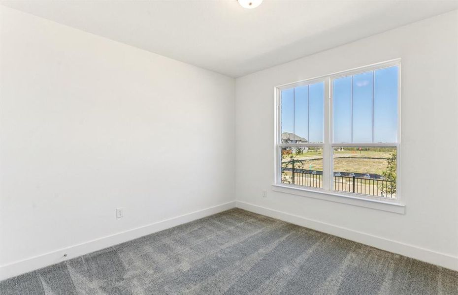 Spacious secondary bedroom with large windows