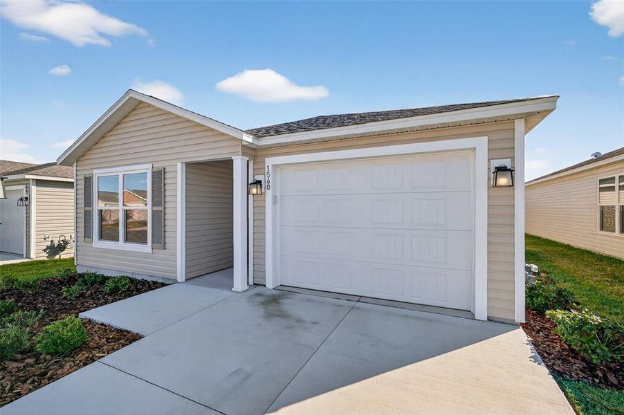 Front exterior of a new home in , The Villages, FL, highlighting curb appeal (Image 18).