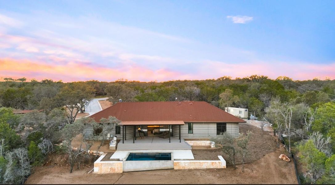 Back of house featuring a patio area and an outdoor pool