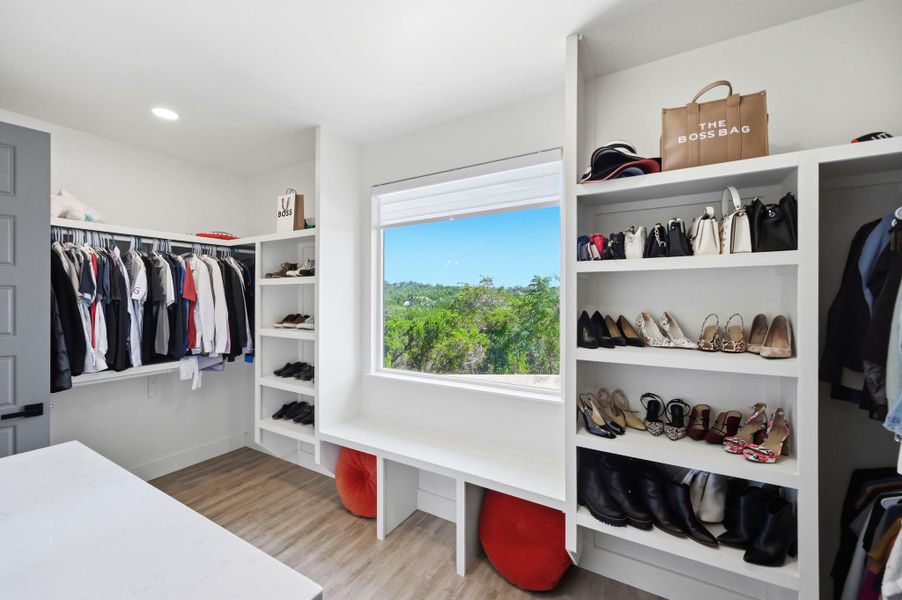 Custom built-in shelving pairs with a large window highlighting scenic green views.