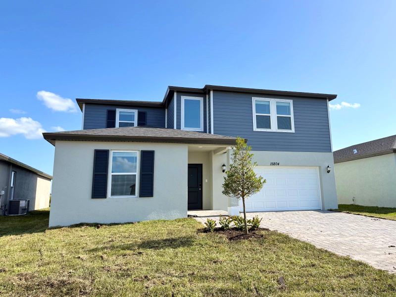 Front exterior of a new home in Meritage Homes at Terra Lago - Classic Series, Indiantown, FL, highlighting curb appeal (Image 11).